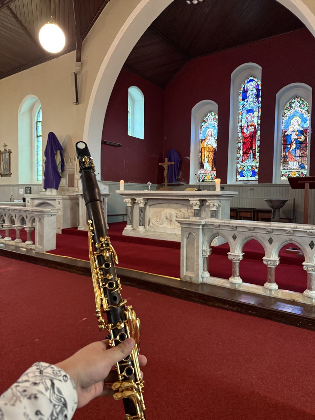 A clarinet held up before the altar of a parish church in Co. Westmeath