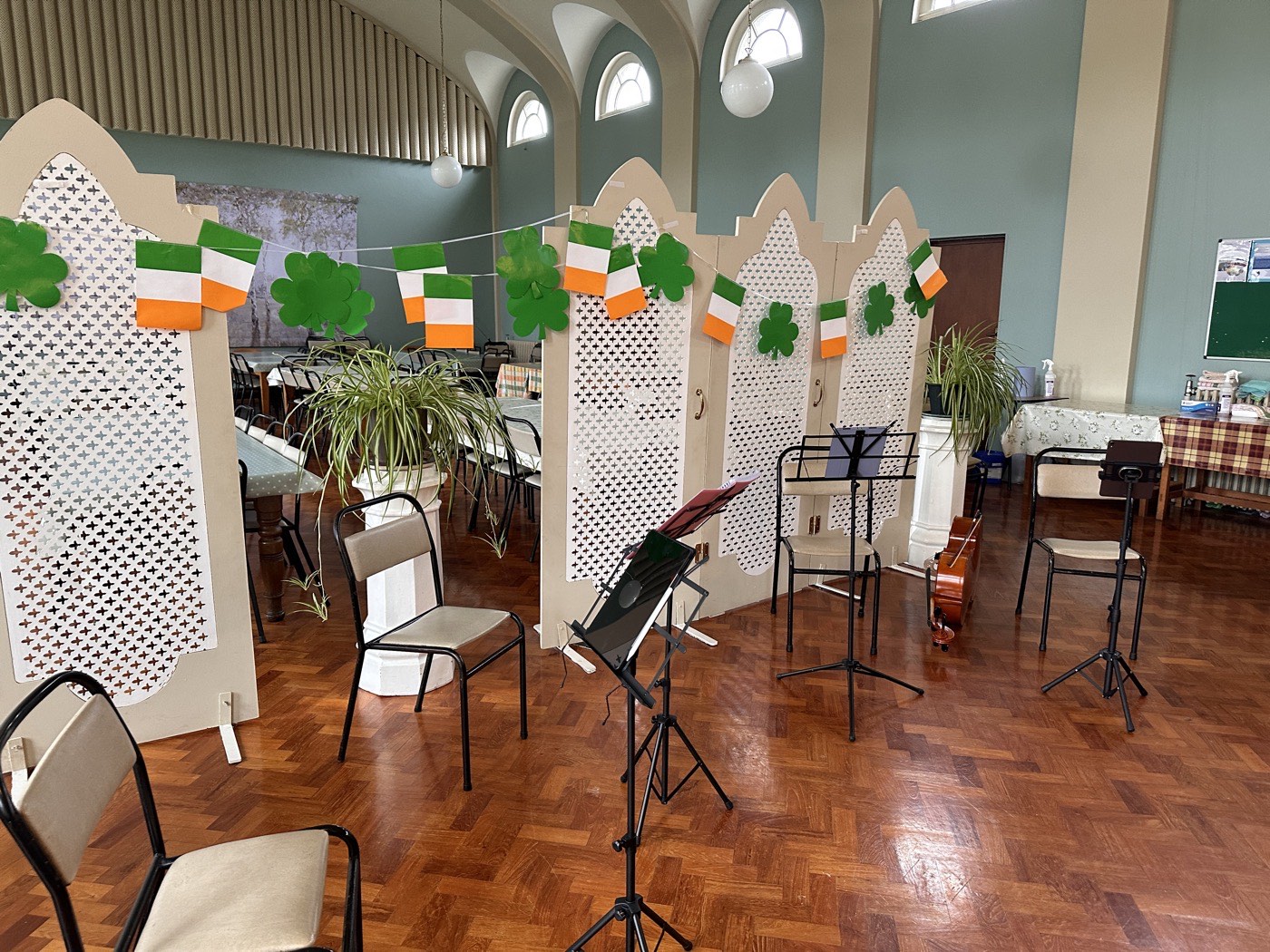 A hall set out with chairs and music stands before a concert, with no one there yet