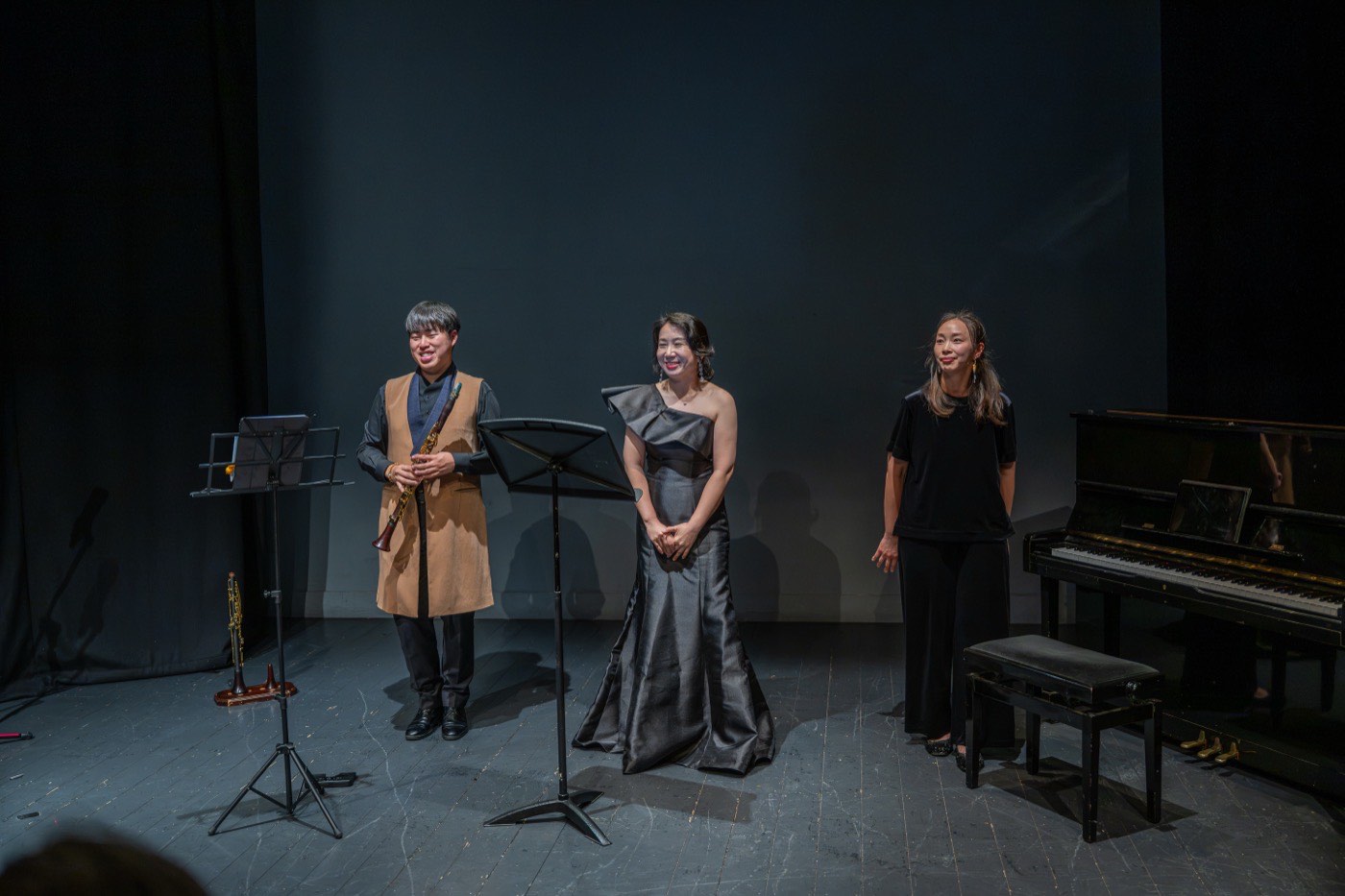 A clarinettist, a soprano and a pianist standing together on the Rua Red stage