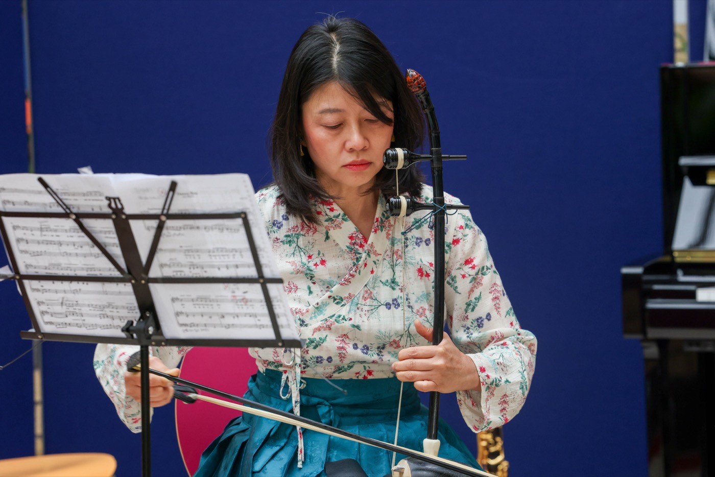 A haegeum player performing in a hospital atrium